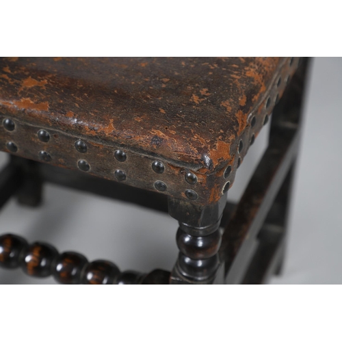 535 - A PAIR OF 17TH CENTURY OAK BACKSTOOLS. with original brass studded leather upholstery on turned and ... 