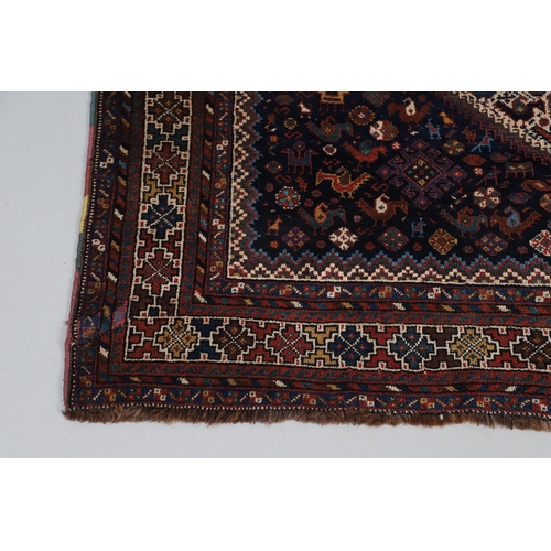 540 - A KHAMSEH RUG, EARLY 20TH CENTURY. the field of tribal devices around three ivory diamond medallions... 