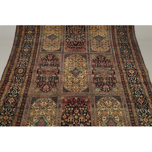 542 - A MASHAD RUG, NORTH EAST KHORASAN, CIRCA 1920. the compartmentalised floral field enclosed by flower... 