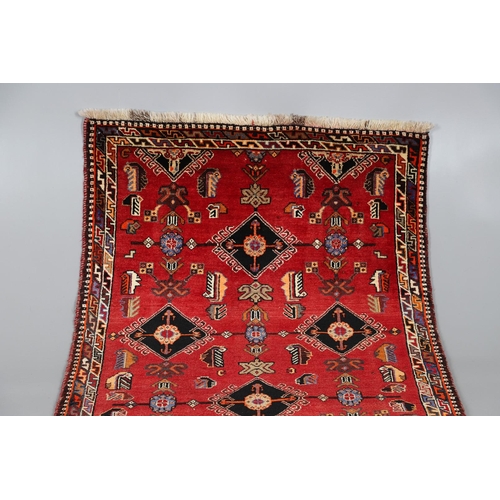 545 - A KASHGAI RUG, 2ND HALF 20TH CENTURY. the raspberry field with columns of serrated leaves enclosed b... 