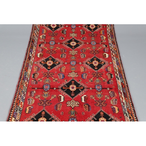 545 - A KASHGAI RUG, 2ND HALF 20TH CENTURY. the raspberry field with columns of serrated leaves enclosed b... 