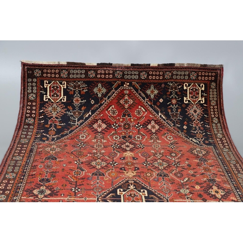 547 - A MODERN KASHGAI RUG. the raspberry lozenge field of stylised plants around an indigo diamond medall... 