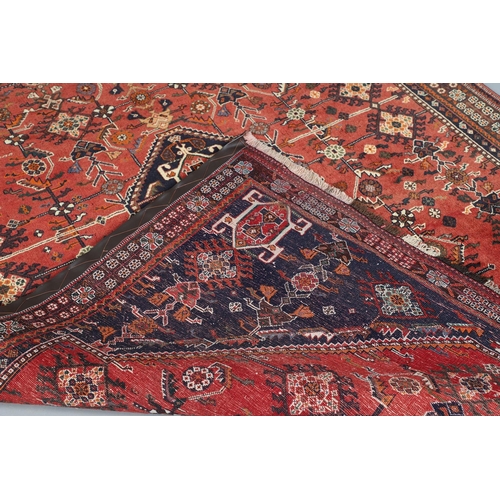 547 - A MODERN KASHGAI RUG. the raspberry lozenge field of stylised plants around an indigo diamond medall... 