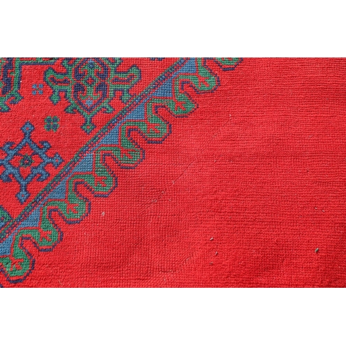 548 - A MAPLES 'TURKEY' CARPET, WEST ANATOLIA, CIRCA 1920. the tomato red field centred by a hexagonal dia... 