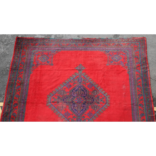 548 - A MAPLES 'TURKEY' CARPET, WEST ANATOLIA, CIRCA 1920. the tomato red field centred by a hexagonal dia... 