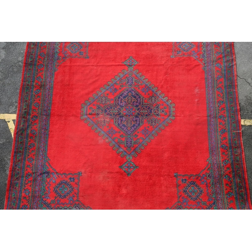 548 - A MAPLES 'TURKEY' CARPET, WEST ANATOLIA, CIRCA 1920. the tomato red field centred by a hexagonal dia... 