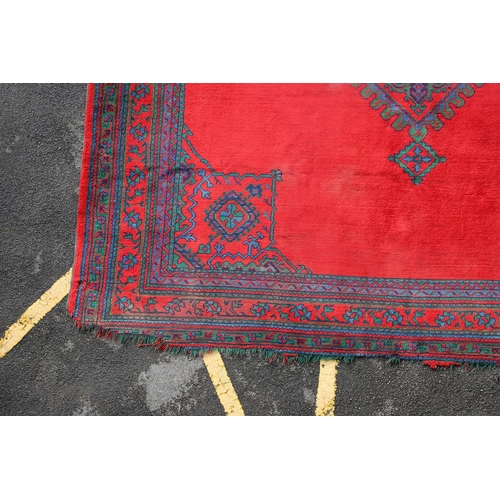 548 - A MAPLES 'TURKEY' CARPET, WEST ANATOLIA, CIRCA 1920. the tomato red field centred by a hexagonal dia... 