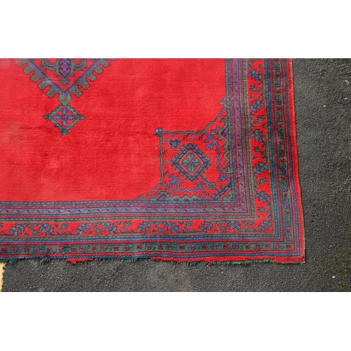 548 - A MAPLES 'TURKEY' CARPET, WEST ANATOLIA, CIRCA 1920. the tomato red field centred by a hexagonal dia... 