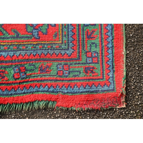 548 - A MAPLES 'TURKEY' CARPET, WEST ANATOLIA, CIRCA 1920. the tomato red field centred by a hexagonal dia... 