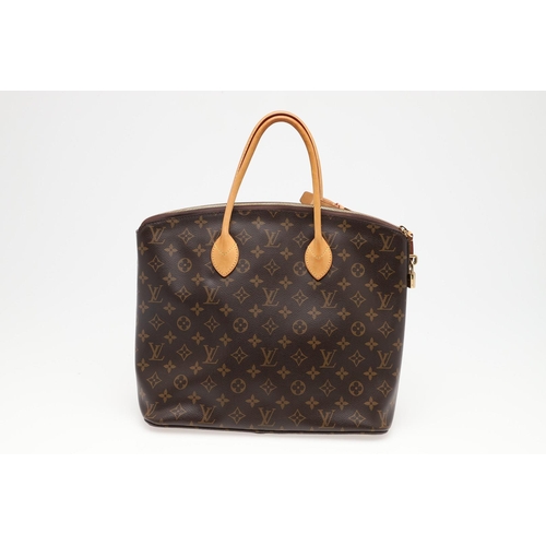 554 - LOUIS VUITTON 'LOCK IT' HANDBAG. A monogrammed canvas and leather handbag, with a brass lock on one ... 