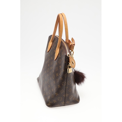 554 - LOUIS VUITTON 'LOCK IT' HANDBAG. A monogrammed canvas and leather handbag, with a brass lock on one ... 