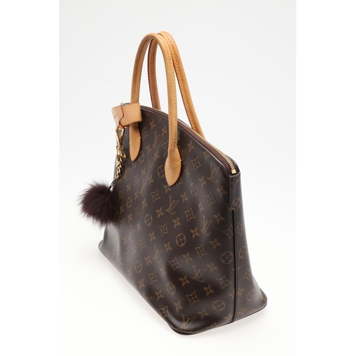 554 - LOUIS VUITTON 'LOCK IT' HANDBAG. A monogrammed canvas and leather handbag, with a brass lock on one ... 