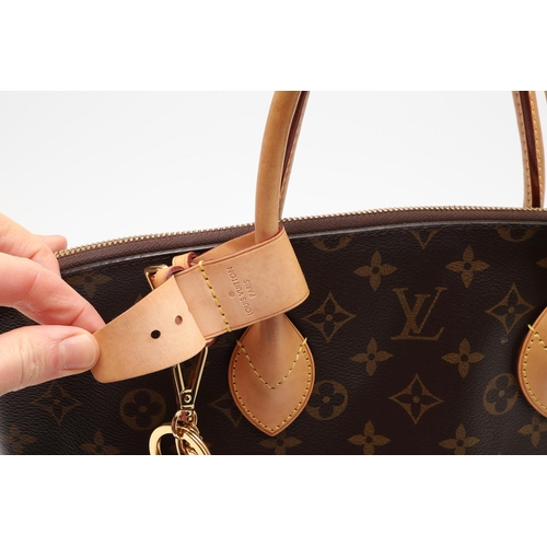 554 - LOUIS VUITTON 'LOCK IT' HANDBAG. A monogrammed canvas and leather handbag, with a brass lock on one ... 