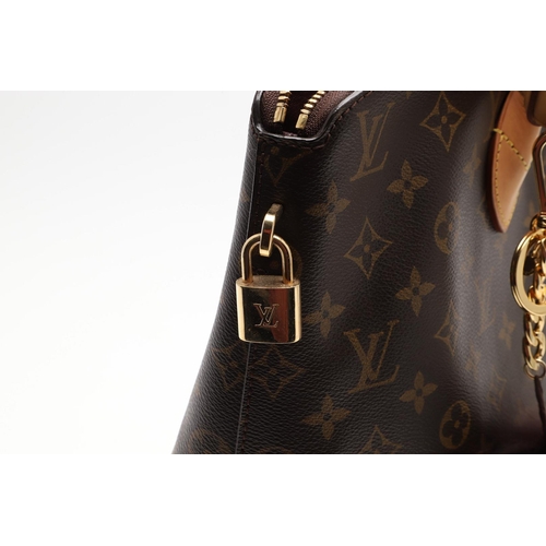 554 - LOUIS VUITTON 'LOCK IT' HANDBAG. A monogrammed canvas and leather handbag, with a brass lock on one ... 