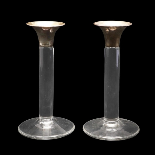 653 - PAIR OF CONTEMPORARY SILVER TOP & GLASS CANDLESTICKS. A pair of glass candlesticks with a circular f... 