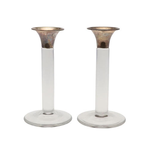 653 - PAIR OF CONTEMPORARY SILVER TOP & GLASS CANDLESTICKS. A pair of glass candlesticks with a circular f... 