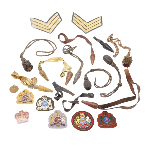 121 - A COLLECTION OF SWORD KNOTS AND MILITARY BADGES. A collection of nine sword knots, various patterns ... 