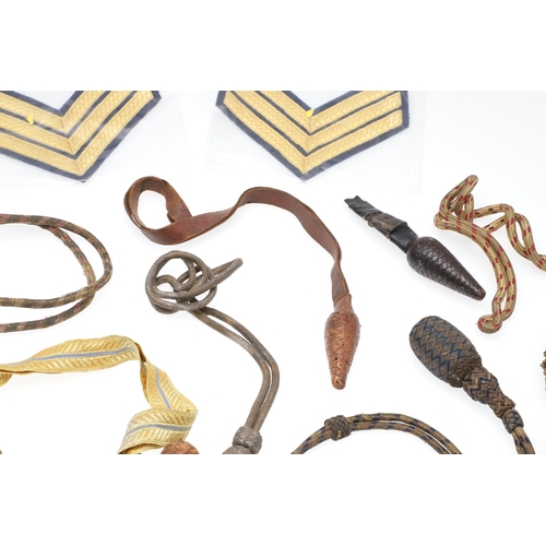 121 - A COLLECTION OF SWORD KNOTS AND MILITARY BADGES. A collection of nine sword knots, various patterns ... 