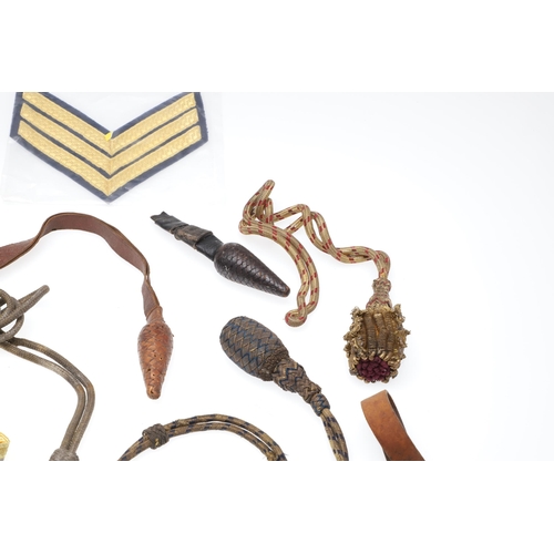 121 - A COLLECTION OF SWORD KNOTS AND MILITARY BADGES. A collection of nine sword knots, various patterns ... 