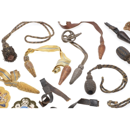 121 - A COLLECTION OF SWORD KNOTS AND MILITARY BADGES. A collection of nine sword knots, various patterns ... 