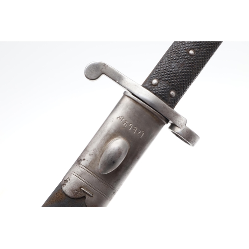 128 - A VICTORIAN MARTINI HENRY 1887 PATTERN BAYONET AND SCABBARD. With a 46 cm pointed single edged blade... 