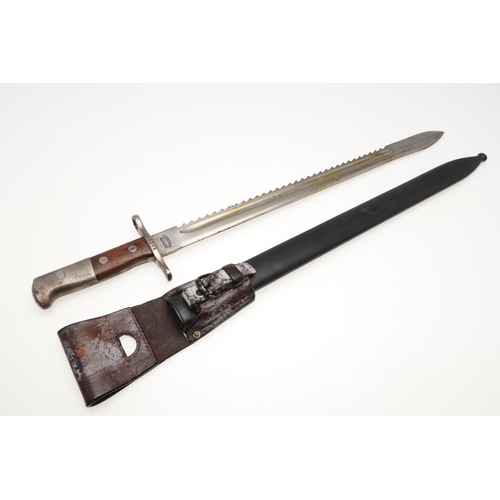 133 - A SWISS 1889 PATTERN SAWBACK BAYONET AND SCABBARD. With a 48 cm blade with a sharpened edge and saw ... 