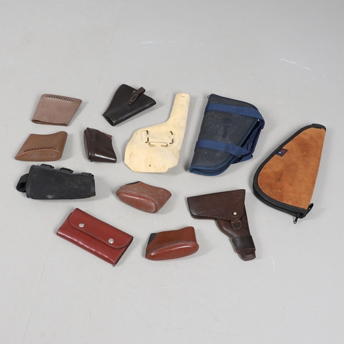 15 - A BROWN LEATHER PISTOL HOLSTER AND OTHERS SIMILAR. A brown leather pistol holder and a selection of ... 