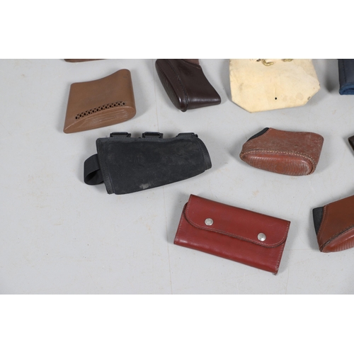 15 - A BROWN LEATHER PISTOL HOLSTER AND OTHERS SIMILAR. A brown leather pistol holder and a selection of ... 