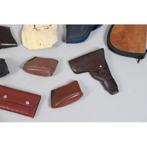 15 - A BROWN LEATHER PISTOL HOLSTER AND OTHERS SIMILAR. A brown leather pistol holder and a selection of ... 