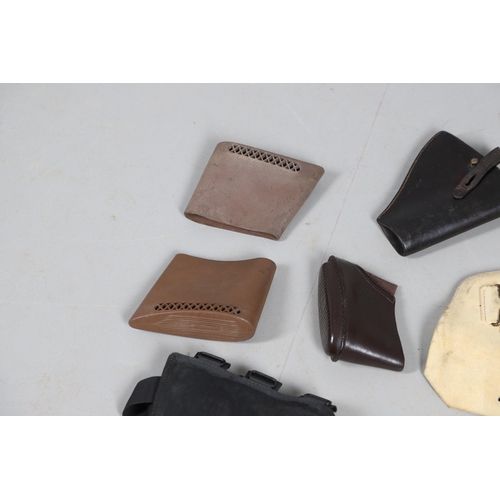 15 - A BROWN LEATHER PISTOL HOLSTER AND OTHERS SIMILAR. A brown leather pistol holder and a selection of ... 