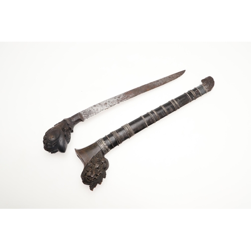 170 - A MALAYAN KRIS WITH CARVED HANDLE AND MOUNTED SCABBARD. ALSO AN AXE. A Malayan Kris with a 24.5 cm s... 