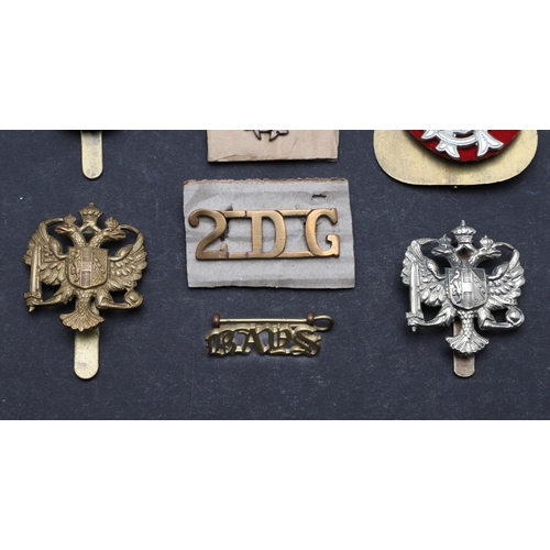 198 - A COLLECTION OF DRAGOON GUARDS BADGES AND INSIGNIA. A collection of badges including a pair of 1st K... 