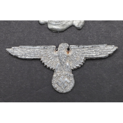 202 - A SECOND WORLD WAR GERMAN SS PEAKED CAP INSIGNIA SET. An insignia set comprising zinc eagle with wid... 