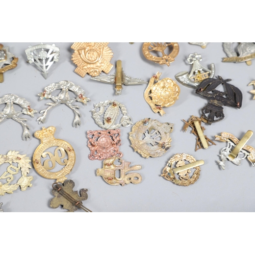 209 - A COLLECTION OF APPROXIMATELY 100 CAP BADGES TO INCLUDE SOUTH LANCASHIRE AND OTHERS. A collection of... 