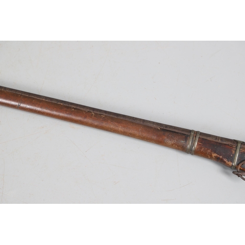 26 - A 19TH CENTURY MATCHLOCK LONG GUN. With a 119 cm barrel tapering from octagonal to round with decora... 