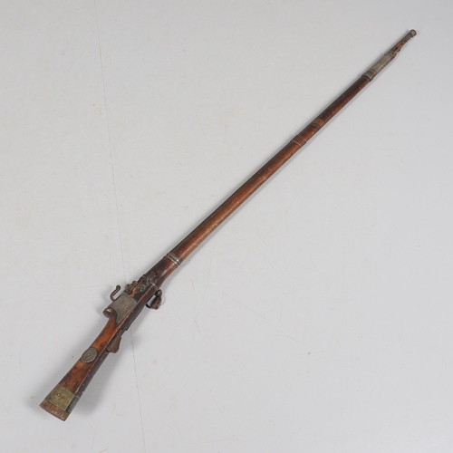 26 - A 19TH CENTURY MATCHLOCK LONG GUN. With a 119 cm barrel tapering from octagonal to round with decora... 