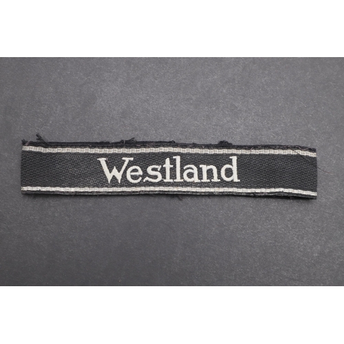 342 - A SECOND WORLD WAR WAFFEN-SS 'WESTLAND' CUFFBAND. A Waffen-SS 'Westland' cuffband. RZM type machine ... 