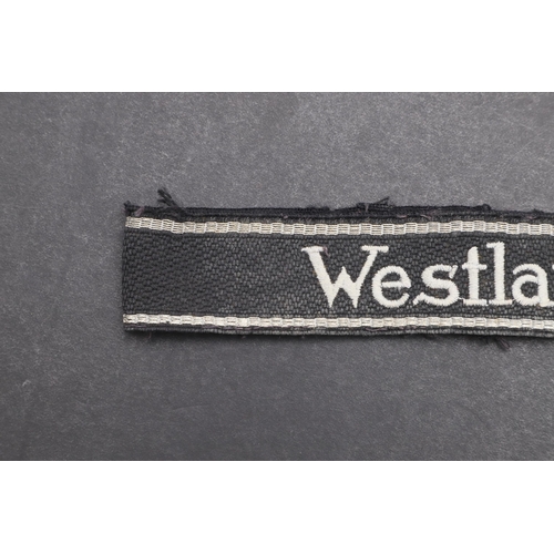 342 - A SECOND WORLD WAR WAFFEN-SS 'WESTLAND' CUFFBAND. A Waffen-SS 'Westland' cuffband. RZM type machine ... 