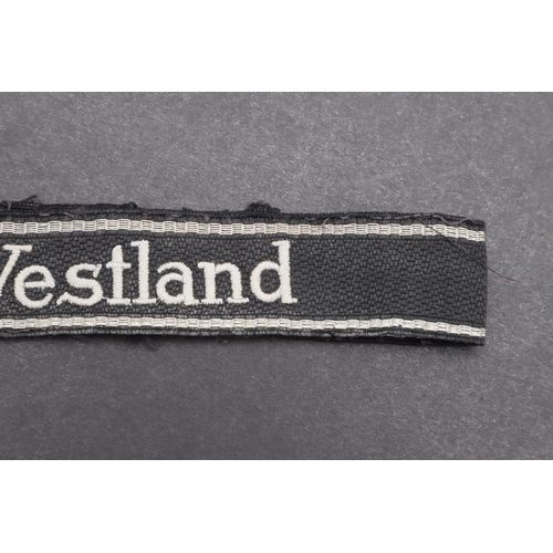 342 - A SECOND WORLD WAR WAFFEN-SS 'WESTLAND' CUFFBAND. A Waffen-SS 'Westland' cuffband. RZM type machine ... 