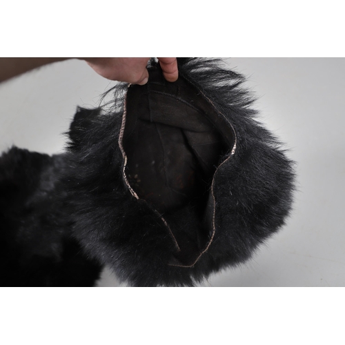 408 - A UNIFORM BEARSKIN COVER AND A SIMILAR MUFF. A unifrom bearskin cover and a similar muff.