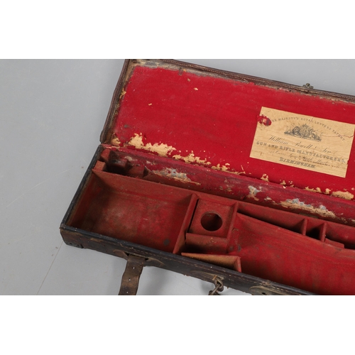 42 - A LEATHER GUN CASE WITH LABEL FOR WILLIAM POWELL AND SONS. A leather gun case, the interior fitted f... 