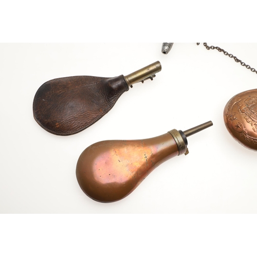 43 - TWO COPPER BODIED POWDER FLASKS AND TWO OTHERS. A copper bodied powder flask decorated with a cannon... 