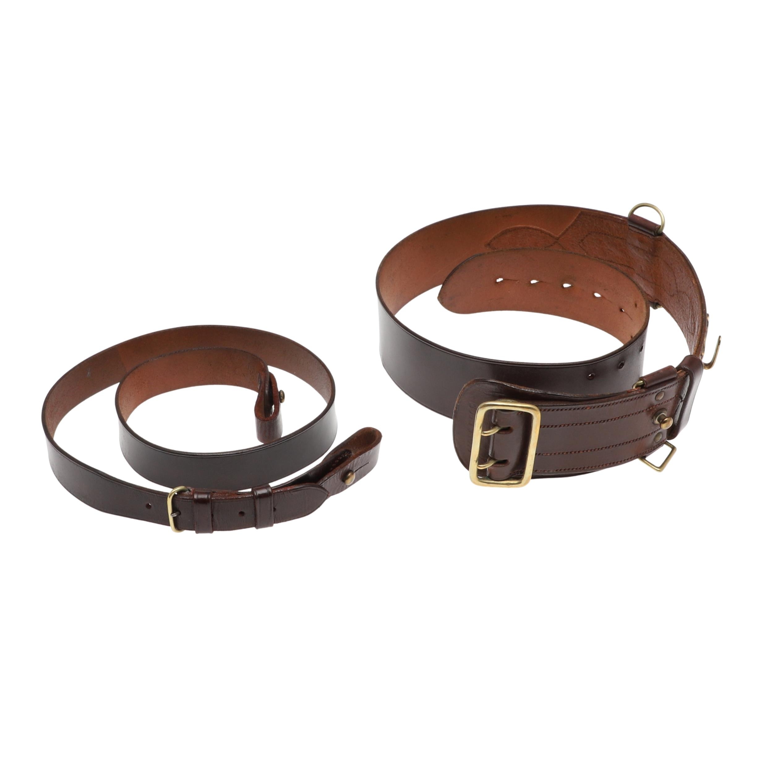 AN OFFICER'S BROWN LEATHER 'SAM BROWNE' BELT AND A SERVICE SCABBARD. A