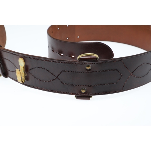 AN OFFICER'S BROWN LEATHER 'SAM BROWNE' BELT AND A SERVICE SCABBARD. A