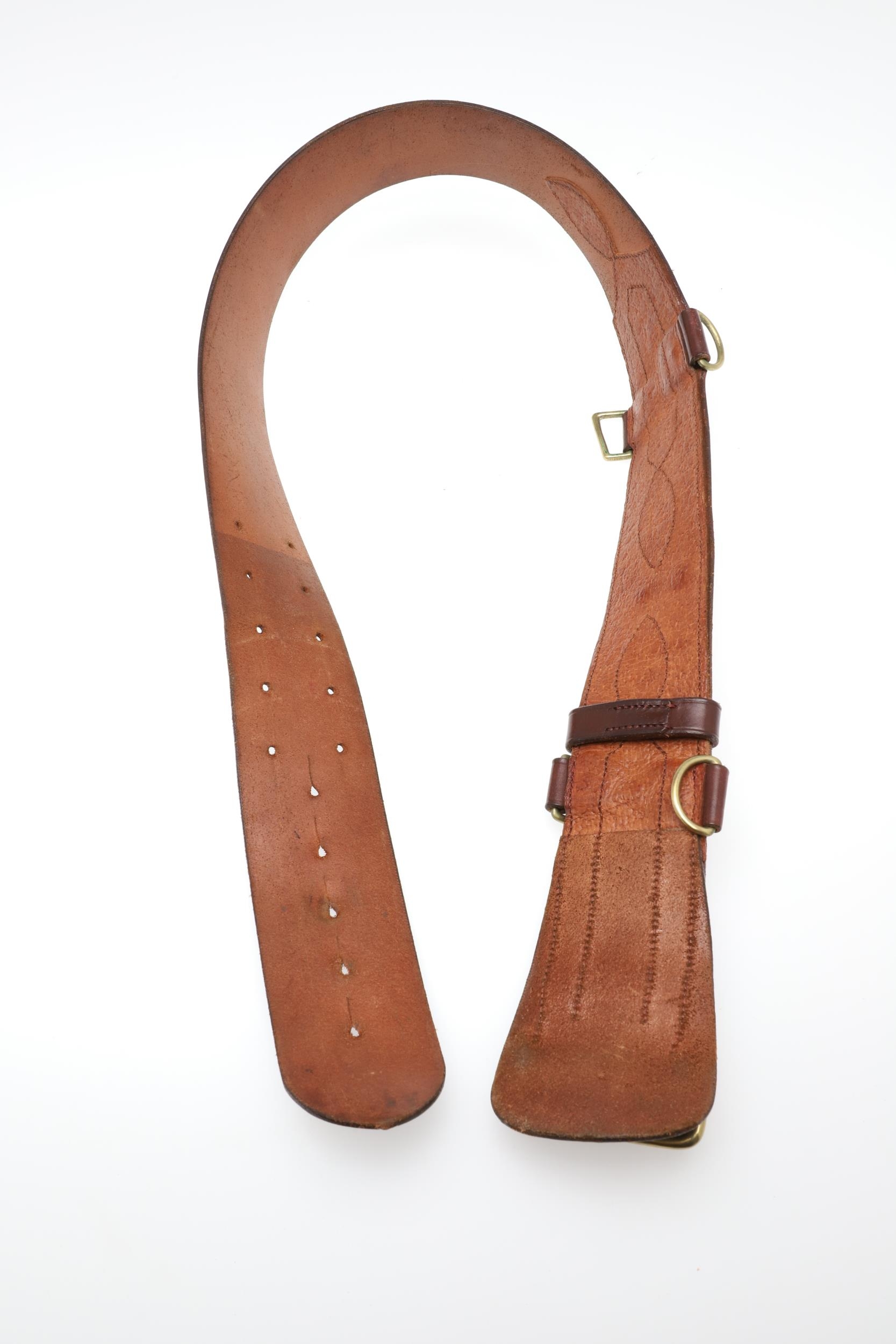 AN OFFICER'S BROWN LEATHER 'SAM BROWNE' BELT AND A SERVICE SCABBARD. A