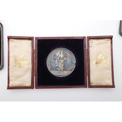 475 - A SILVER PRESENTATION MEDAL FROM THE CONFECTIONERS AND BAKERS EXHIBITION AND TWO OTHERS. A silver aw... 