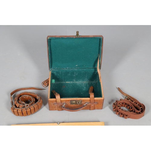 48 - A LEATHER SHOT GUN CASE, TWO BELTS AND A DISPLAY OF CARTRIDGES. A small light brown leather cartridg... 