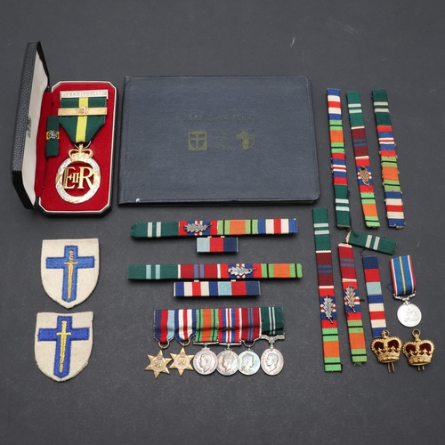 558 - A TERRITORIAL EFFICIENCY MEDAL, A SET OF MINIATURES AND RIBBON BARS. An Elizabeth II Territorial Eff... 