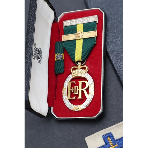 558 - A TERRITORIAL EFFICIENCY MEDAL, A SET OF MINIATURES AND RIBBON BARS. An Elizabeth II Territorial Eff... 