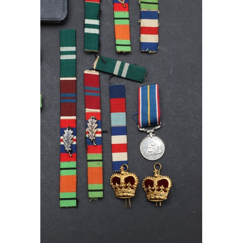 558 - A TERRITORIAL EFFICIENCY MEDAL, A SET OF MINIATURES AND RIBBON BARS. An Elizabeth II Territorial Eff... 